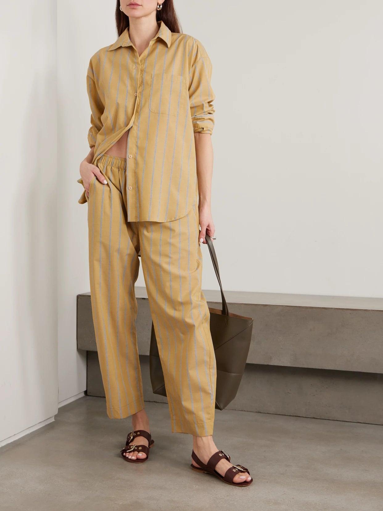 Image of a model wearing Tops. Product name - The Essential Striped Cotton-poplin Shirt in Yellow colour by brand - Jamie Haller