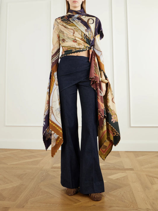 Image of a model wearing Pants. Product name - Valiant Draped Flared Jeans in Blue colour by brand - Zimmermann
