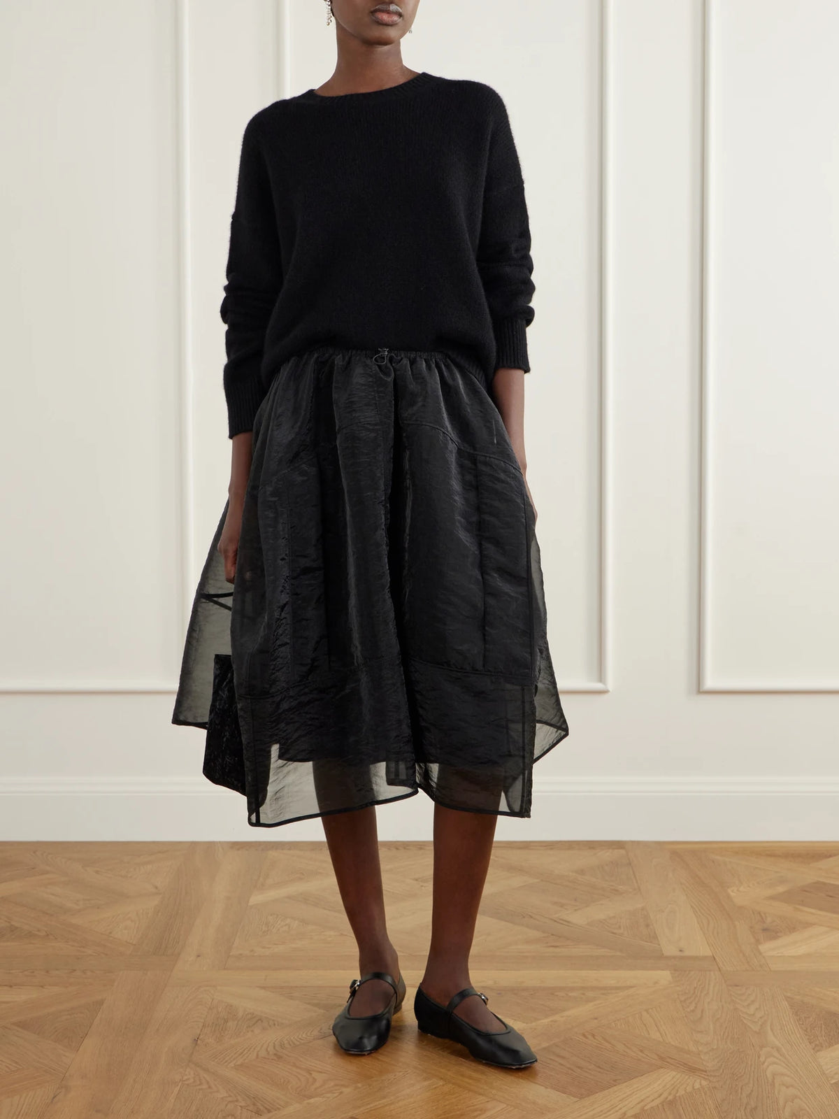 Image of a model wearing Skirts. Product name - Fosia Organza Midi Skirt in Black colour by brand - Cecilie Bahnsen