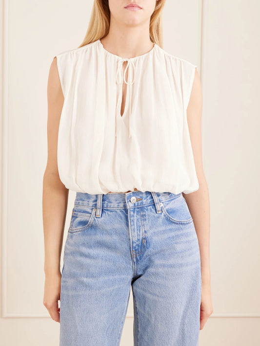 Image of a model wearing Tops. Product name - Wave Cropped Silk Top in Cream colour by brand - FRAME