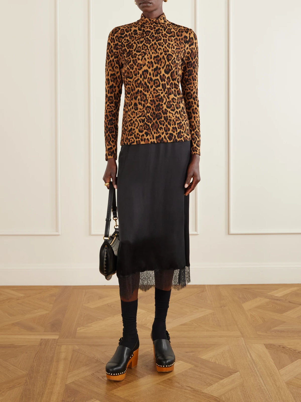 Image of a model wearing Outerwear. Product name - Leopard-print Turtleneck Sweater in Leopard print colour by brand - Anna Sui