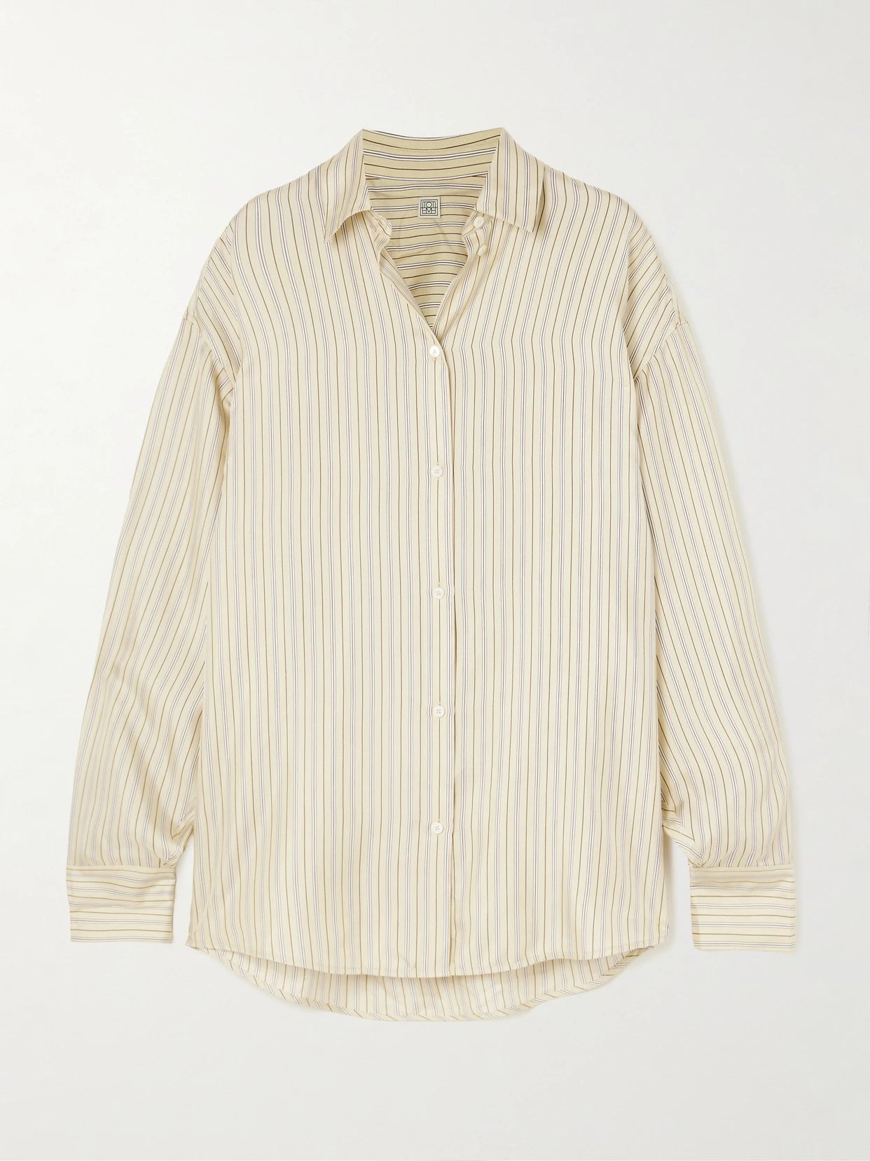 Image of a model wearing Tops. Product name - Oversized Striped Silk Shirt in Beige colour by brand - TOTEME