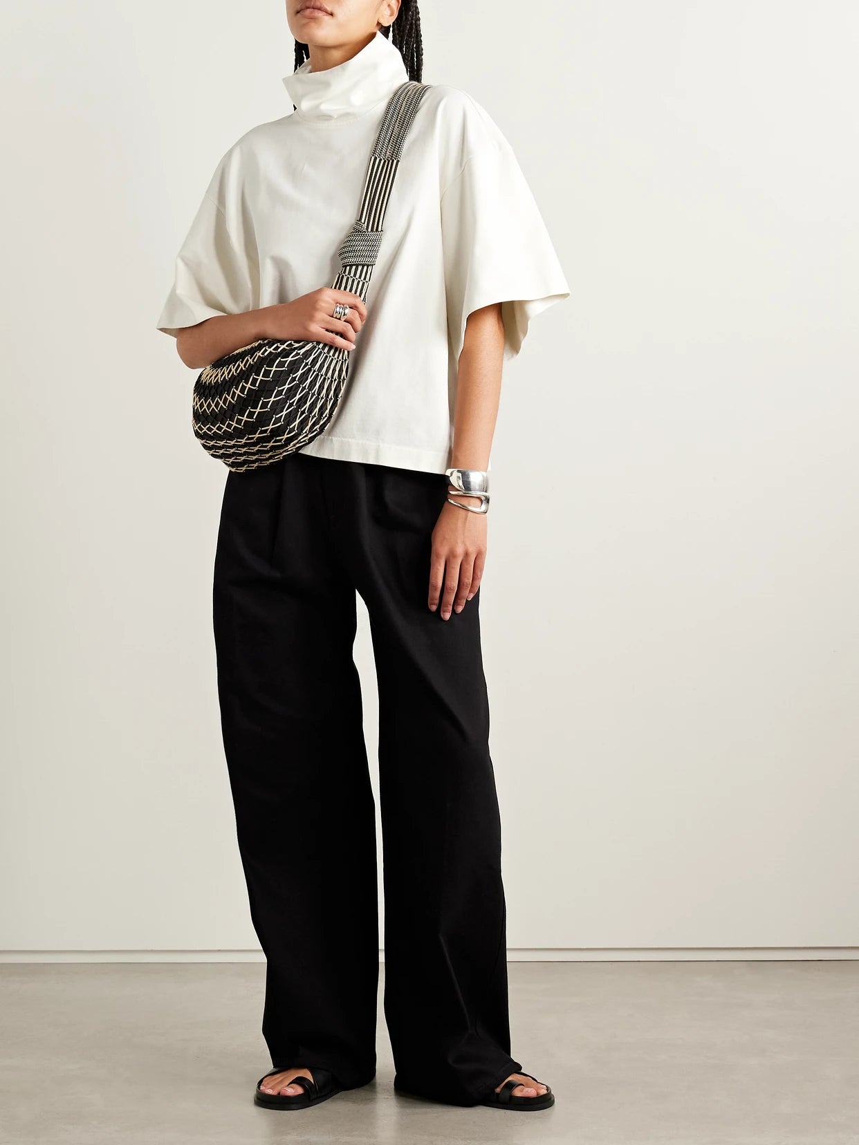 Image of a model wearing Tops. Product name - The Orbital Organic Cotton-jersey Turtleneck T-shirt in Off-white colour by brand - RÙADH