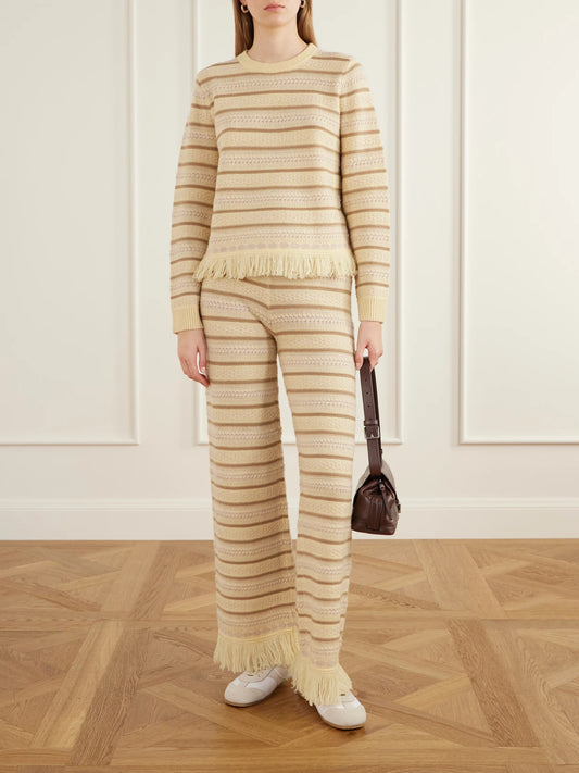 Image of a model wearing Outerwear. Product name - Western Fringe-detail Striped Wool And Cashmere-blend Sweater in Multi colour by brand - Guest In Residence