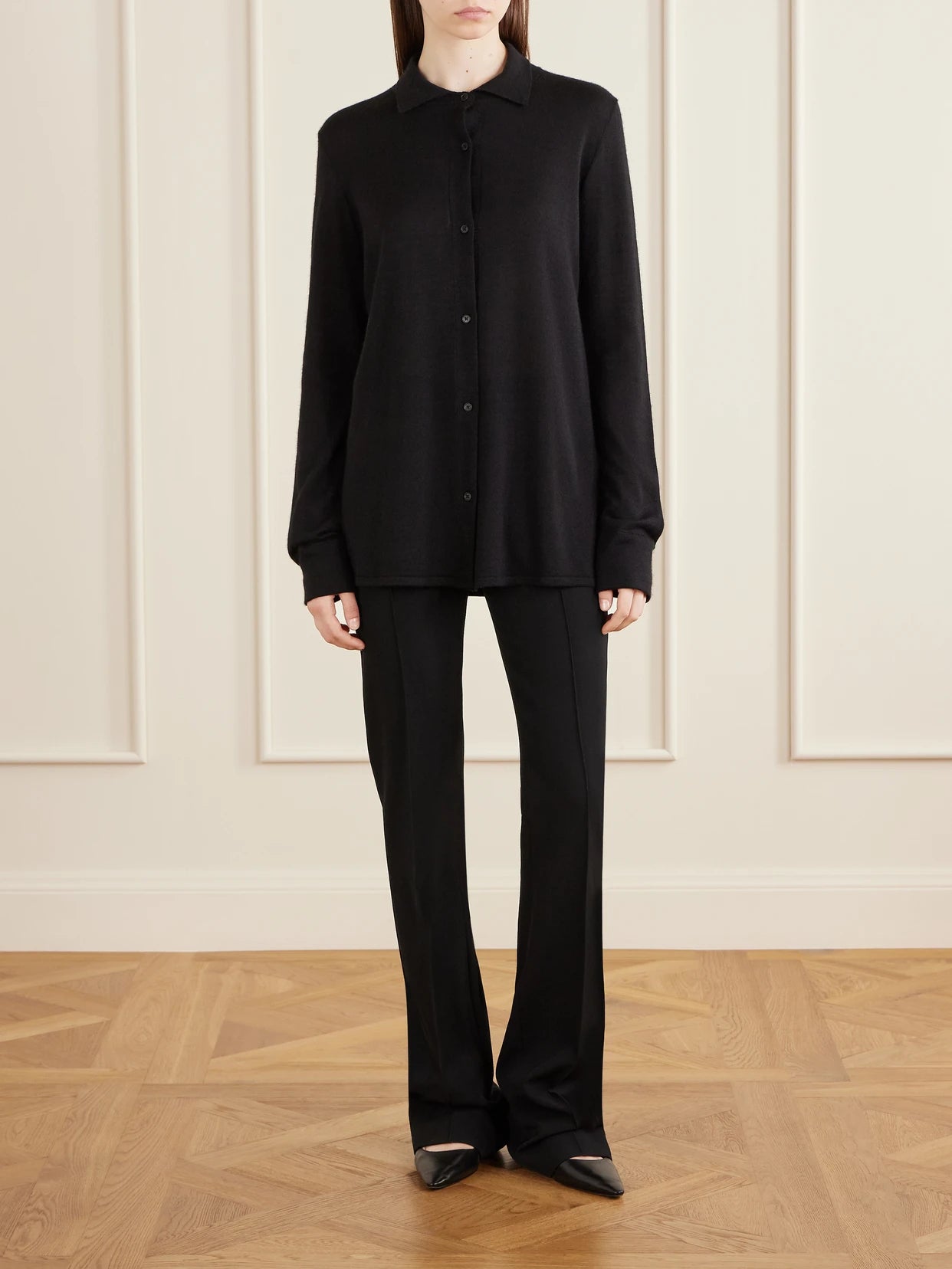 Image of a model wearing Outerwear. Product name - Ocari Cashmere And Silk-blend Polo Knit in Black colour by brand - The Row