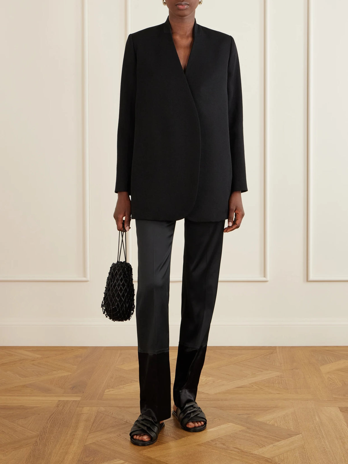 Image of a model wearing Pants. Product name - Sue Paneled Satin Straight-leg Pants in Black colour by brand - Sharon Wauchob