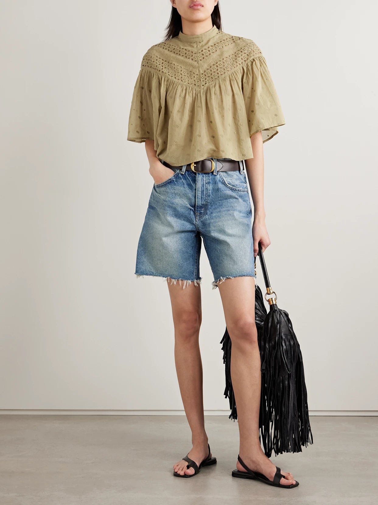 Image of a model wearing Tops. Product name - Mikki Embroidered Broderie Anglaise Cotton-voile Blouse in Sage green colour by brand - Nili Lotan