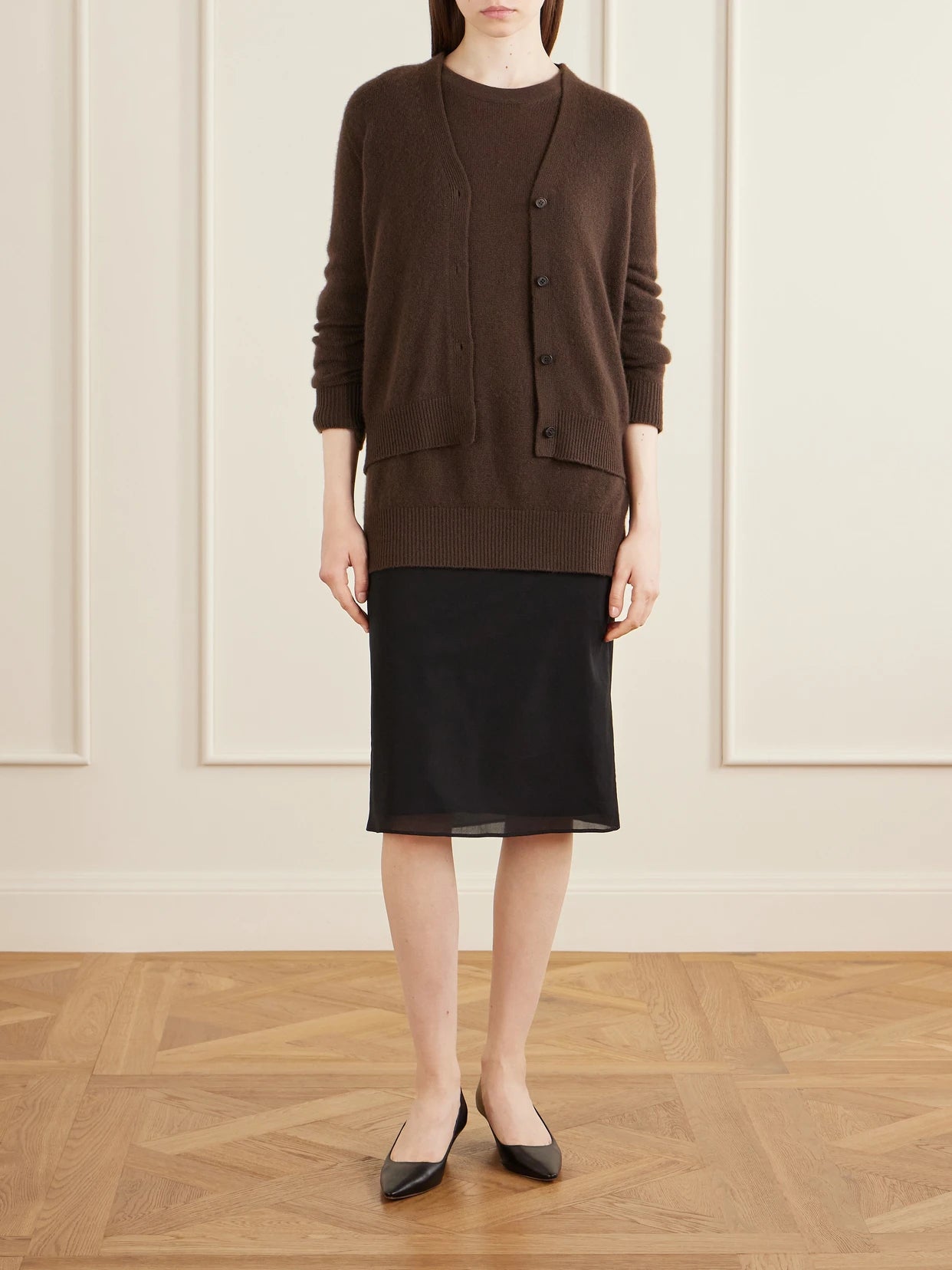 Image of a model wearing Outerwear. Product name - Ovida Cashmere Cardigan in Dark brown colour by brand - The Row
