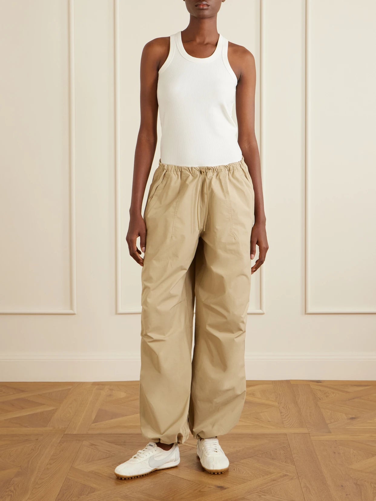 Image of a model wearing Pants. Product name - Woven Balloon Pants in Camel colour by brand - ON