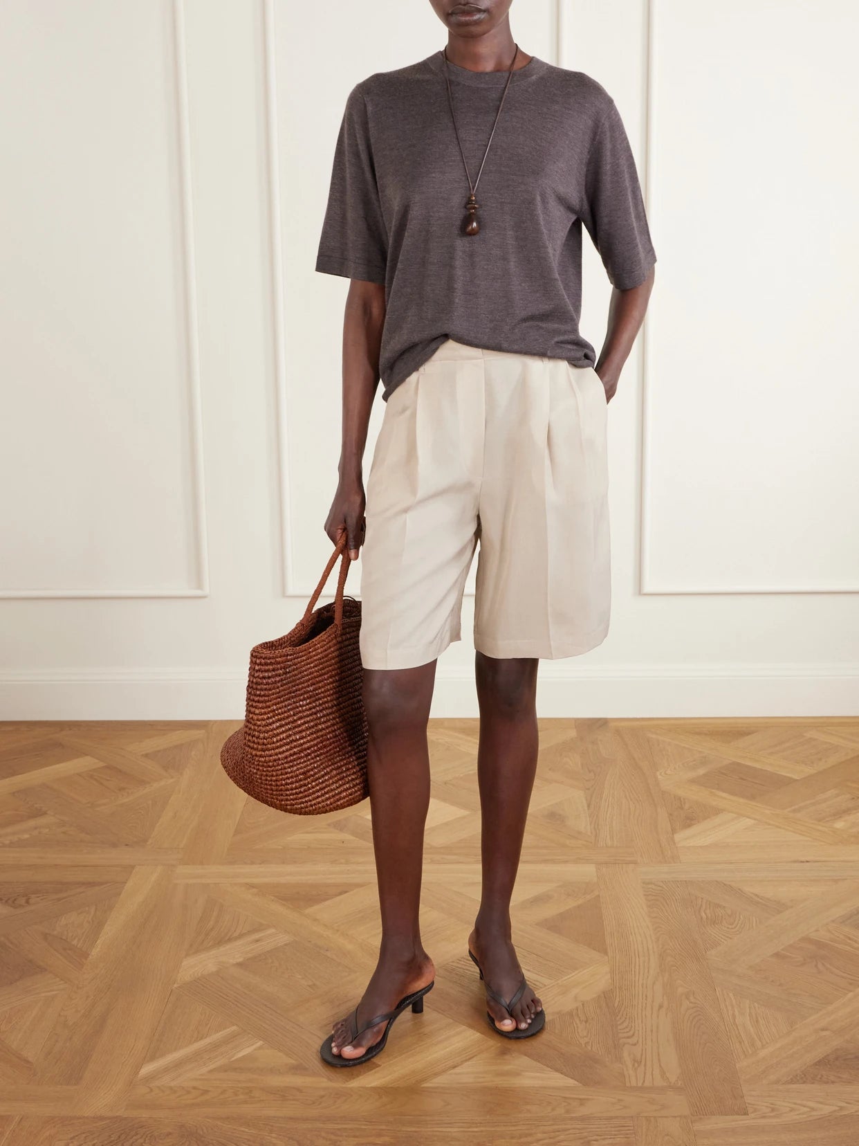 Image of a model wearing Shorts. Product name - Kim Pleated Woven Shorts in Beige colour by brand - LESET