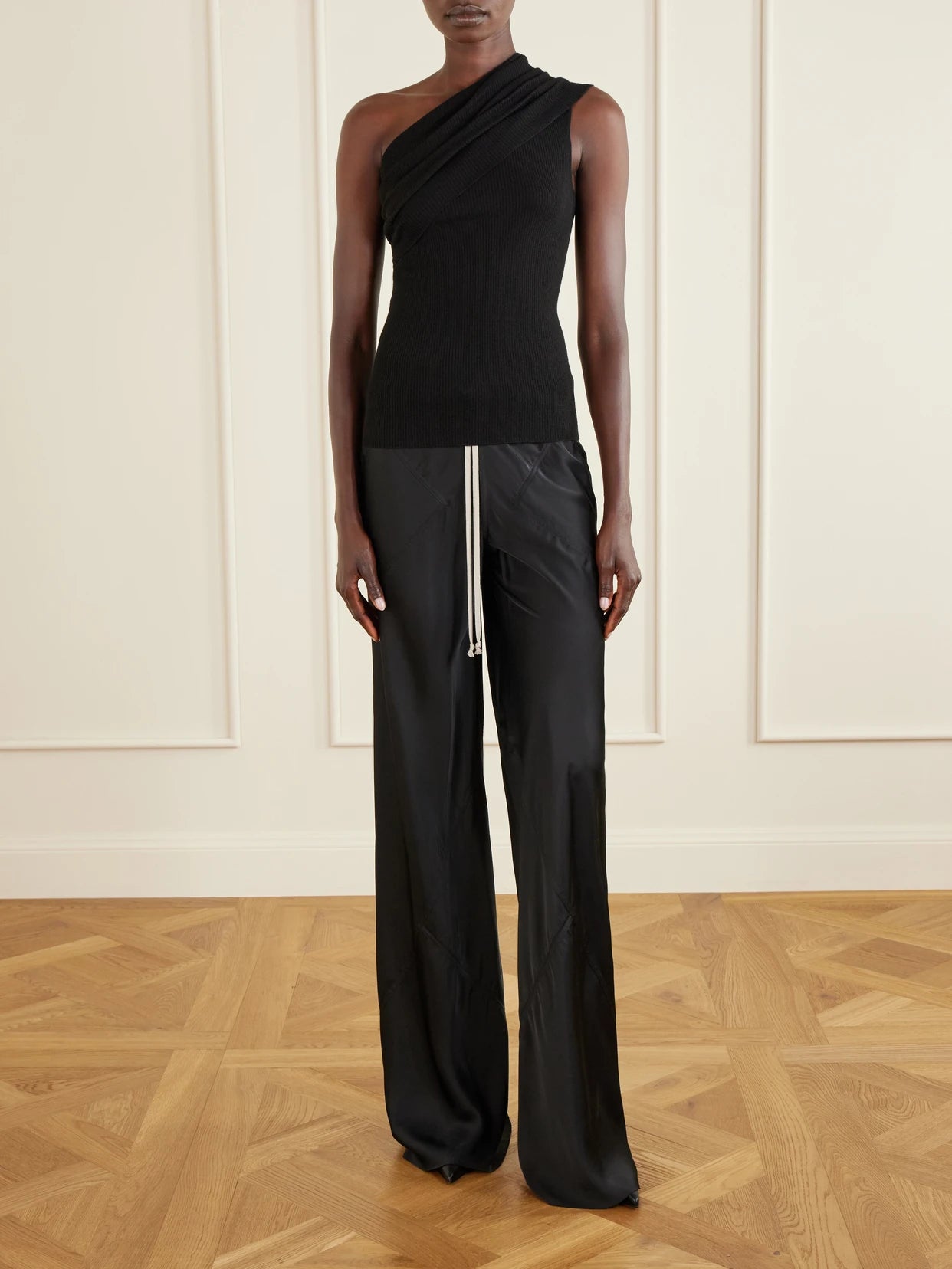 Image of a model wearing Tops. Product name - Athena One-shoulder Ribbed-knit Wool Top in Black colour by brand - Rick Owens