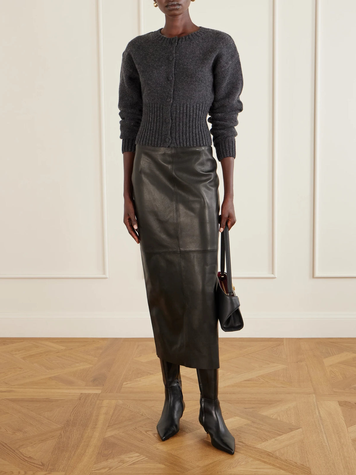 Image of a model wearing Skirts. Product name - Selly Paneled Leather Maxi Skirt in Black colour by brand - Nour Hammour