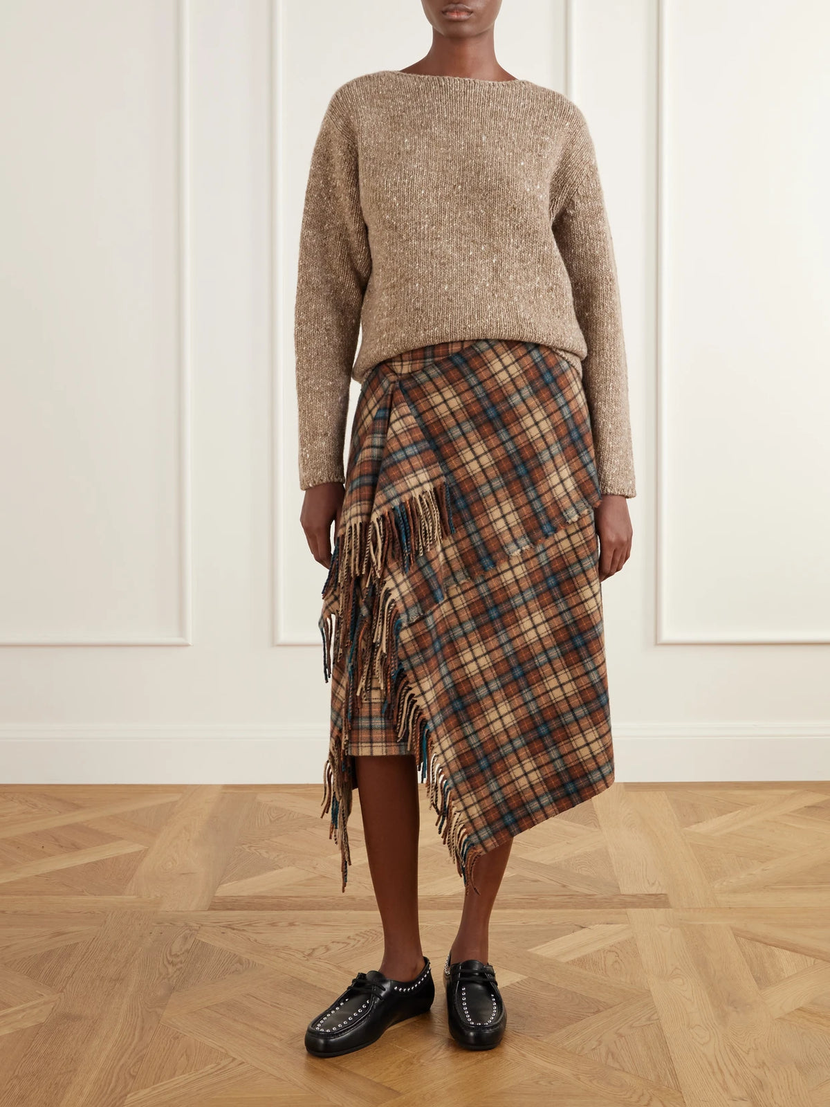 Image of a model wearing Outerwear. Product name - Wool Sweater in Brown colour by brand - Auralee