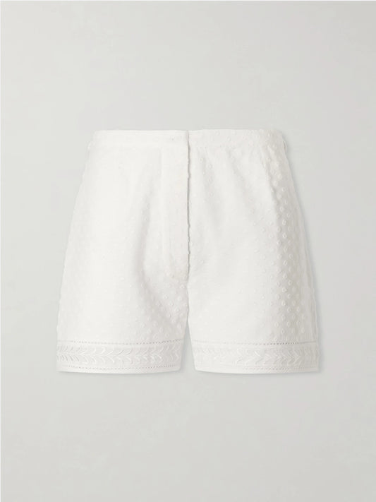 Image of a model wearing Shorts. Product name - Armand Polka-dot Lace-embroidered Cotton-voile Shorts in White colour by brand - Thierry Colson
