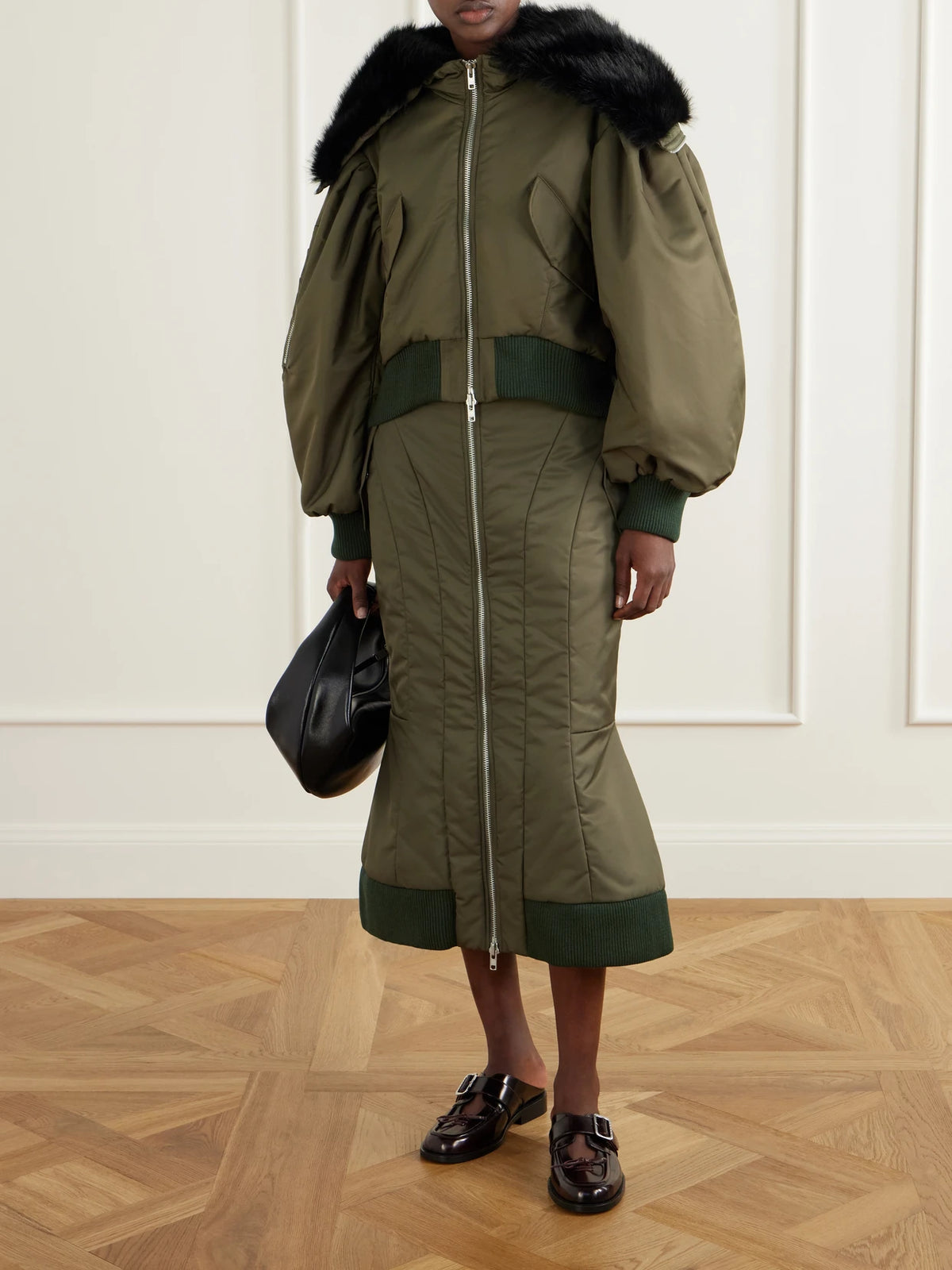 Image of a model wearing Skirts. Product name - Satin Midi Skirt in Army green colour by brand - Simone Rocha