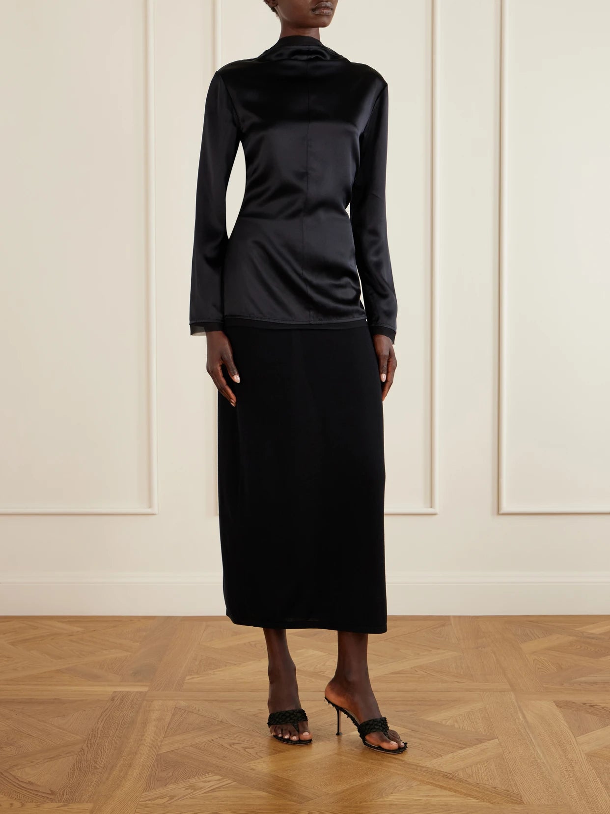 Image of a model wearing Tops. Product name - Beau Open-back Tie-detailed Silk Blouse in Black colour by brand - TOVE