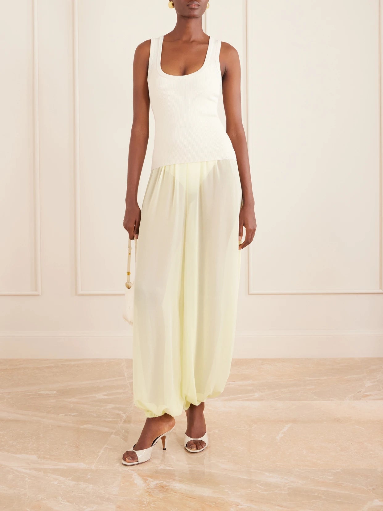 Image of a model wearing Pants. Product name - Mio Crepe Wide-leg Pants in Pastel yellow colour by brand - The Frankie Shop