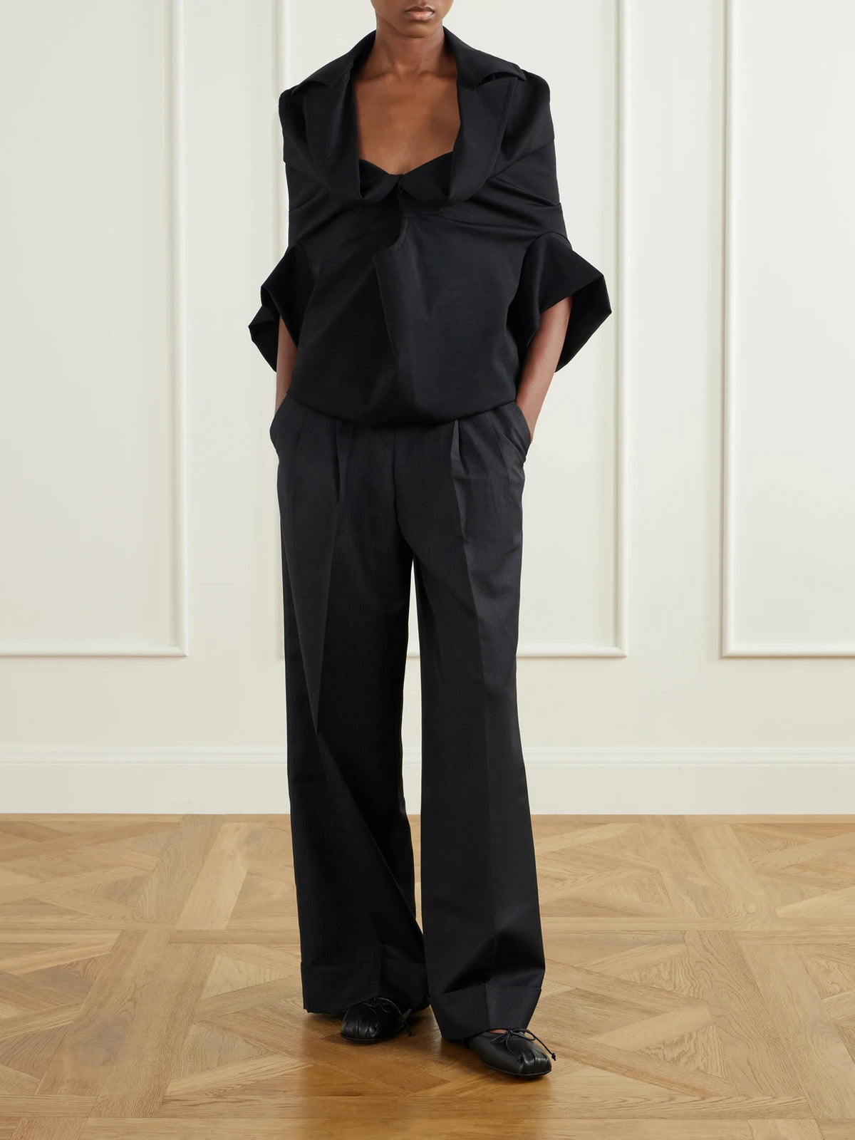 Image of a model wearing Tops. Product name - Wool-blend Blouse in Black colour by brand - Junya Watanabe