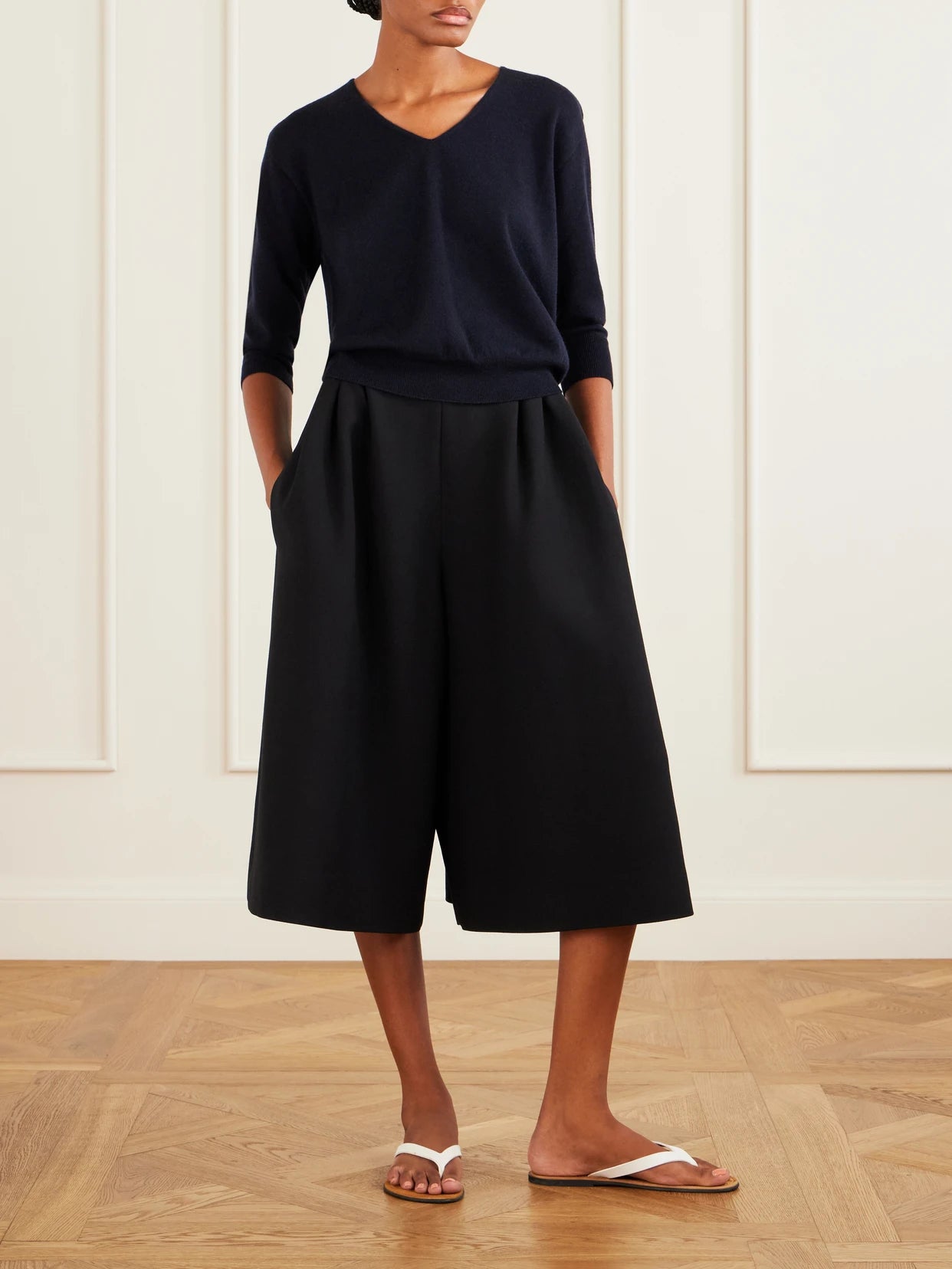 Image of a model wearing Outerwear. Product name - Orchidea Cashmere Knit Sweater in Navy colour by brand - The Row