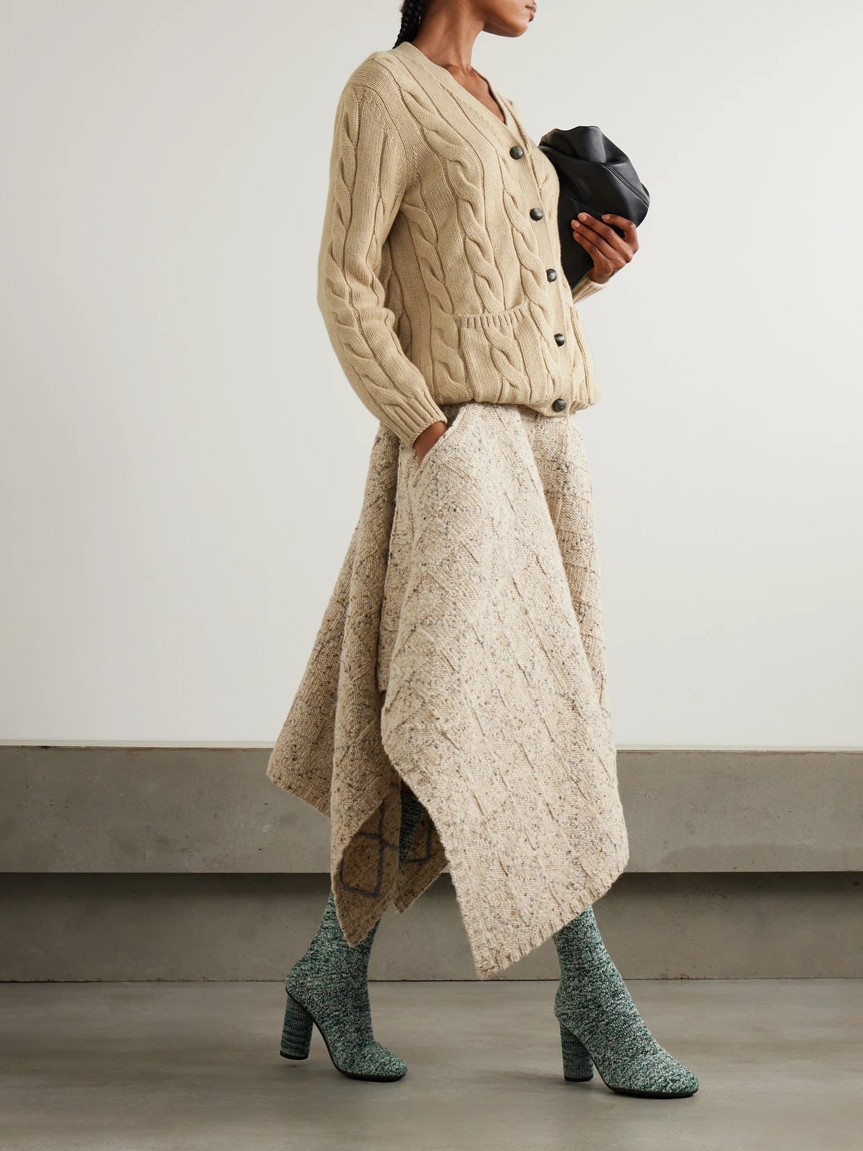 Image of a model wearing Outerwear. Product name - Napier Cable-knit Cashmere Cardigan in Beige colour by brand - Loro Piana