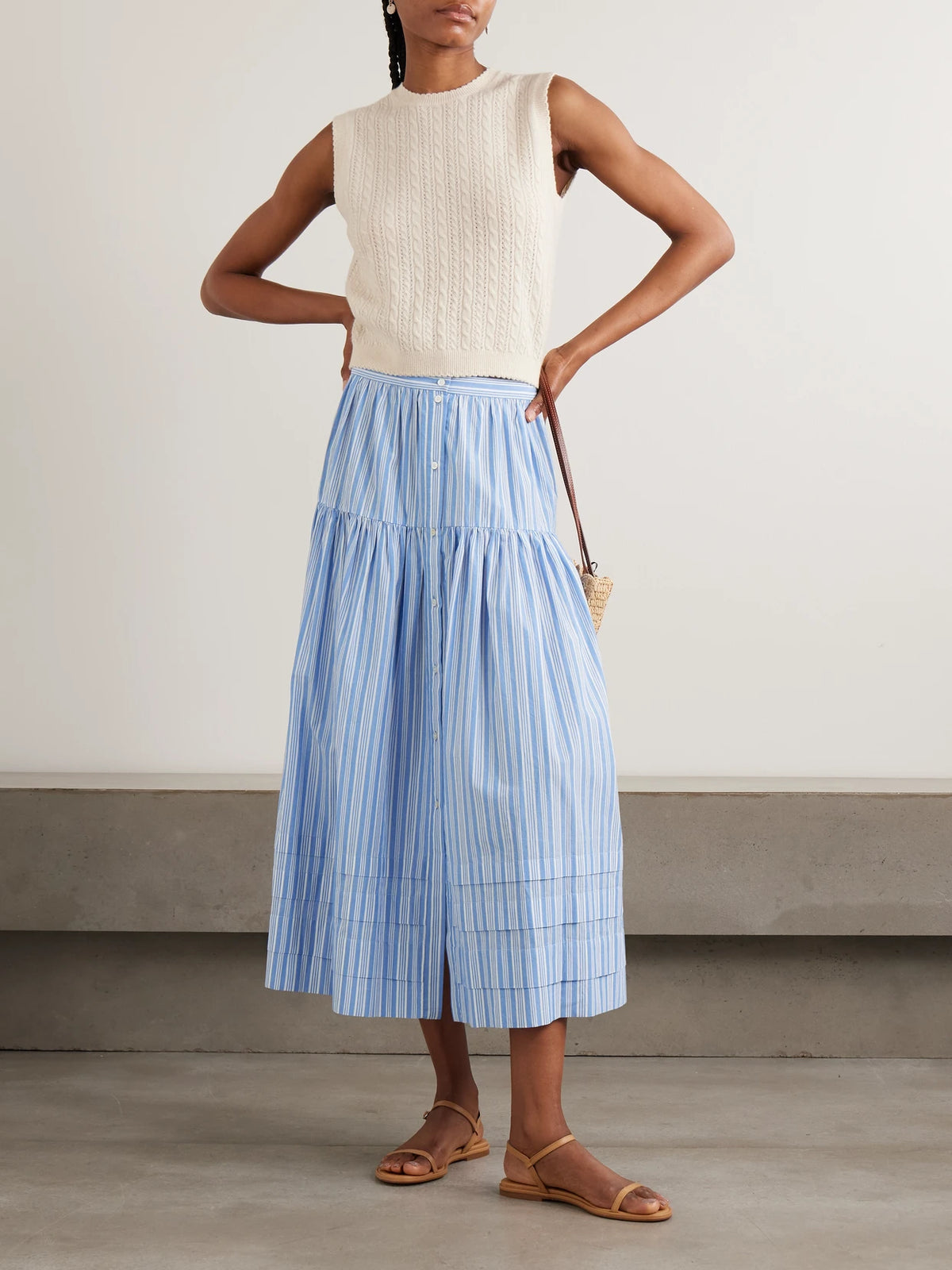 Image of a model wearing Skirts. Product name - Marceline Tiered Striped Organic Cotton Midi Skirt in Blue colour by brand - DÔEN