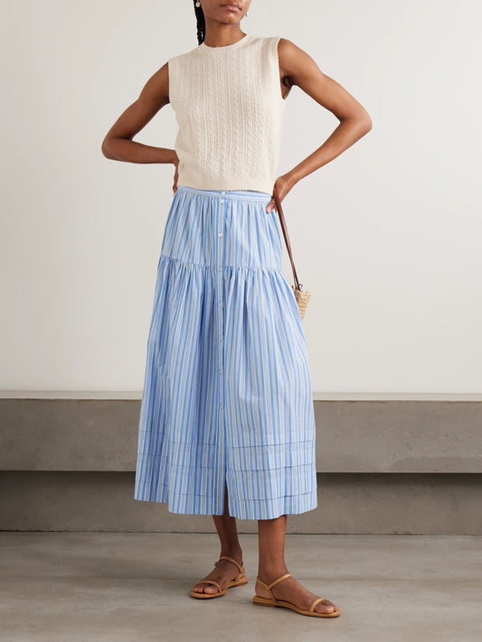 Image of a model wearing Skirts. Product name - Marceline Tiered Striped Organic Cotton Midi Skirt in Blue colour by brand - DÔEN