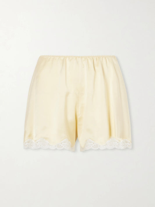 Image of a model wearing Shorts. Product name - Lace-trimmed Silk-satin Shorts in Yellow colour by brand - Chloé