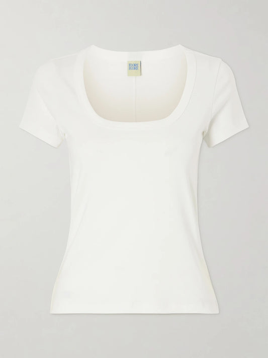 Image of a model wearing Tops. Product name - Lulu Baby Tee Organic Cotton-jersey T-shirt in White colour by brand - FLORE FLORE