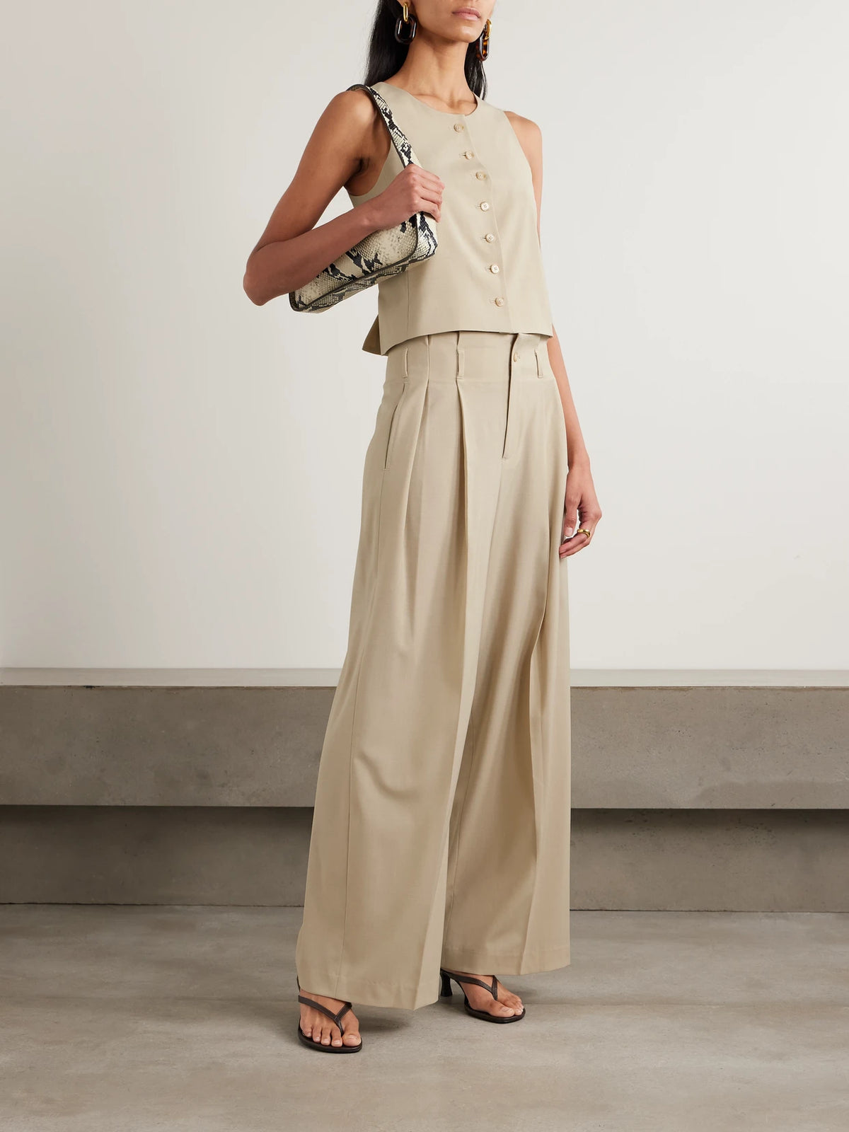 Image of a model wearing Pants. Product name - Percie Pleated Wool-blend Wide-leg Pants in Beige colour by brand - KALLMEYER
