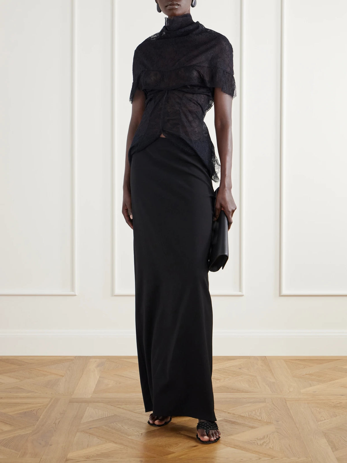 Image of a model wearing Tops. Product name - Draped Ruffled Lace Blouse in Black colour by brand - Colleen Allen