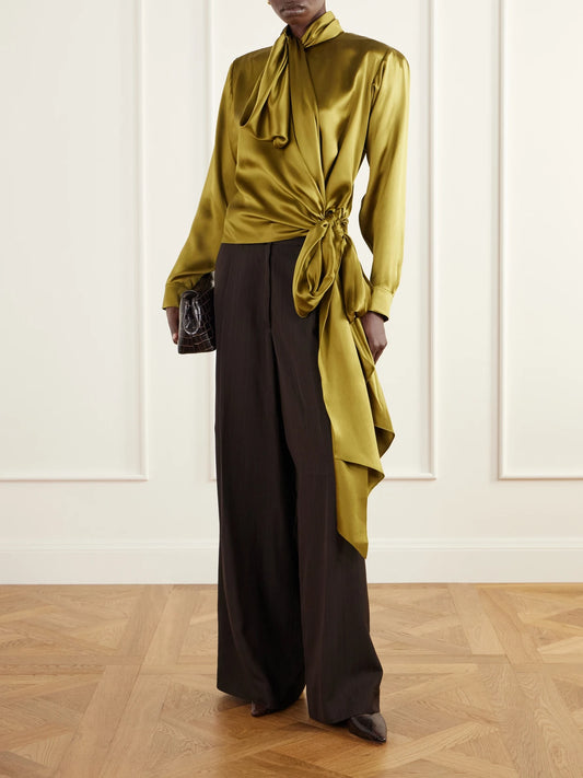 Image of a model wearing Tops. Product name - Tie-detailed Silk-satin Blouse in Army green colour by brand - Balmain