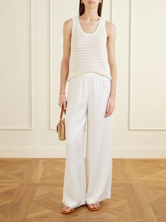 Image of a model wearing Tops. Product name - Arie Open-knit Cotton-blend Tank in Ecru colour by brand - Anine Bing