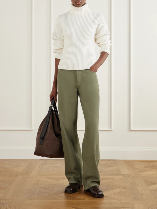 Image of a model wearing Outerwear. Product name - Miller Ribbed Cotton Turtleneck Sweater in Cream colour by brand - Still Here