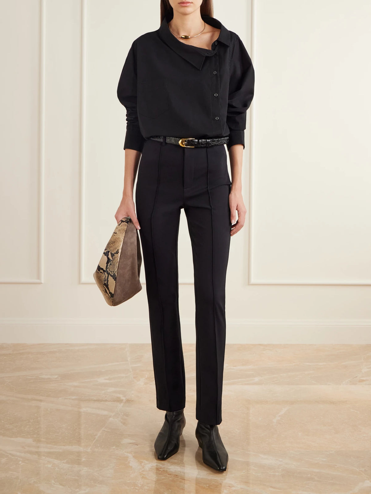 Image of a model wearing Pants. Product name - The Riding Cropped Stretch-crepe Slim-leg Pants in Black colour by brand - Jamie Haller