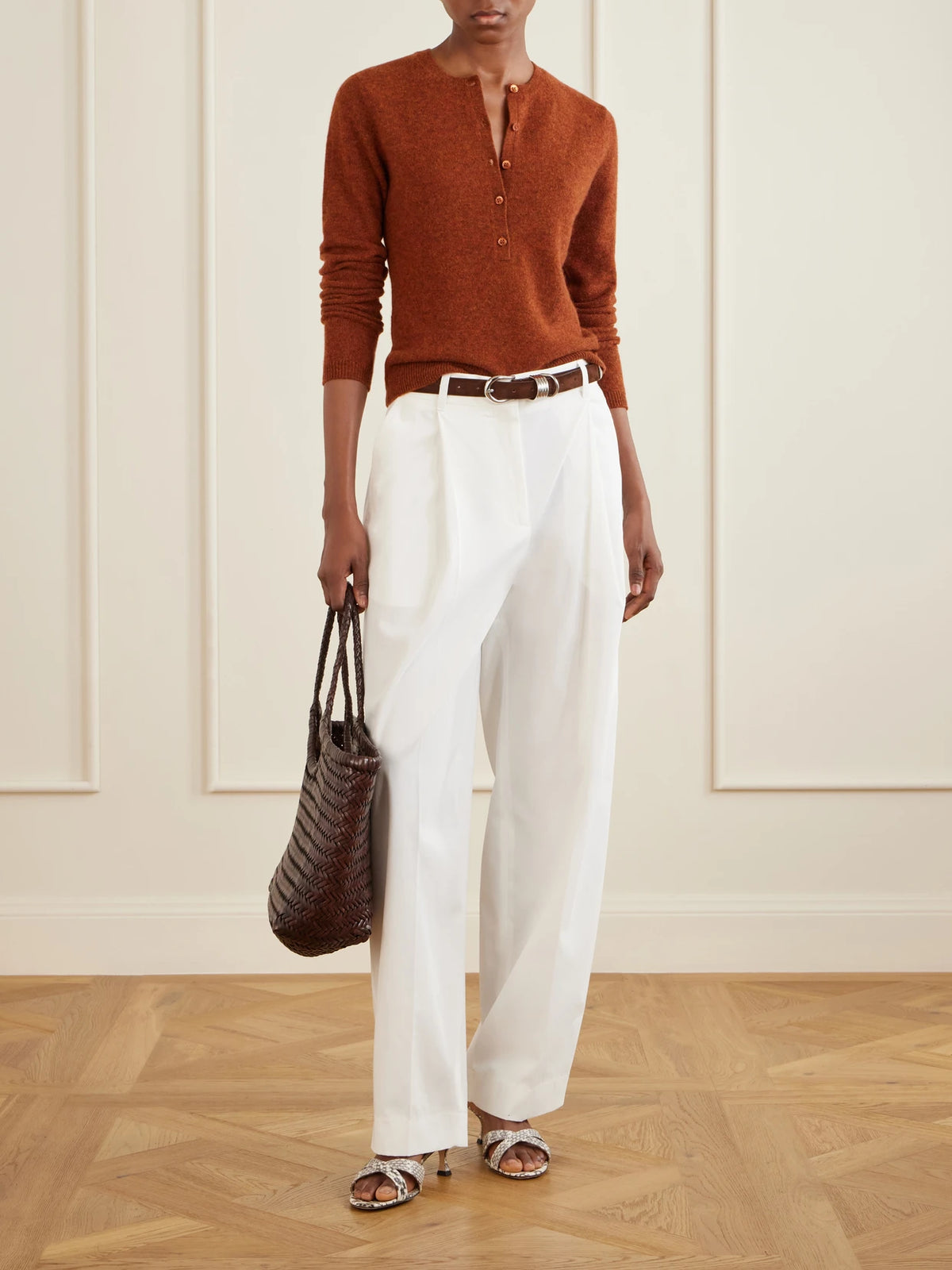 Image of a model wearing Outerwear. Product name - Heath Henley Cashmere Sweater in Brick colour by brand - DÔEN