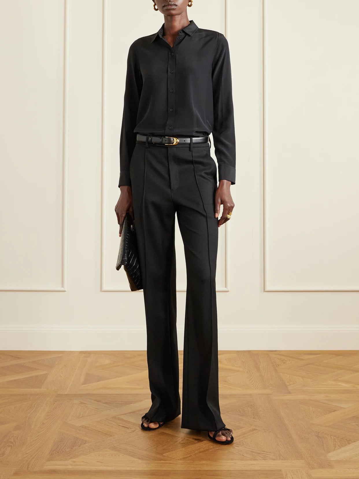 Image of a model wearing Pants. Product name - Etoile Wool-twill Straight-leg Pants in Black colour by brand - Nili Lotan