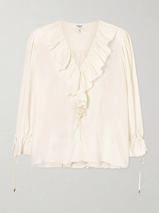 Image of a model wearing Tops. Product name - Ruffled Silk Crepe De Chine Blouse in White colour by brand - Chloé