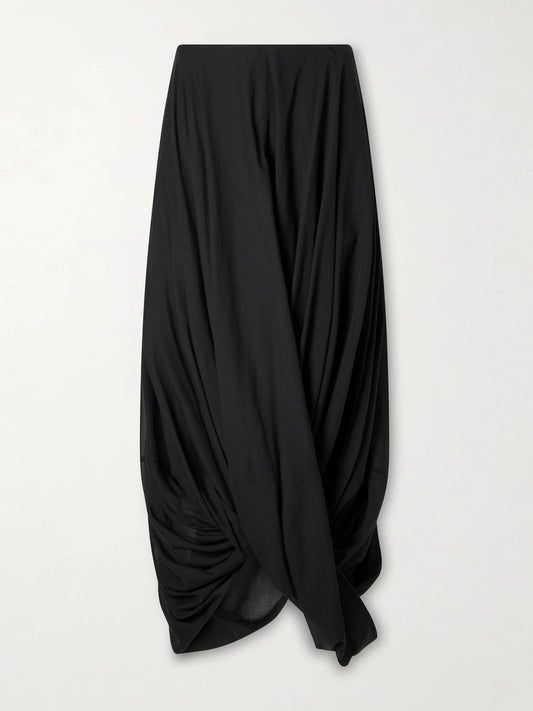 Image of a model wearing Skirts. Product name - Cocoon Draped Lyocell And Organic Cotton-blend Maxi Skirt in Black colour by brand - TOTEME