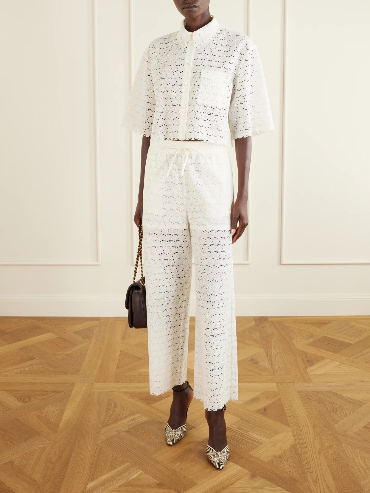 Image of a model wearing Pants. Product name - Mossi Broderie Anglaise Cotton Straight-leg Pants in Ivory colour by brand - Valentino Garavani