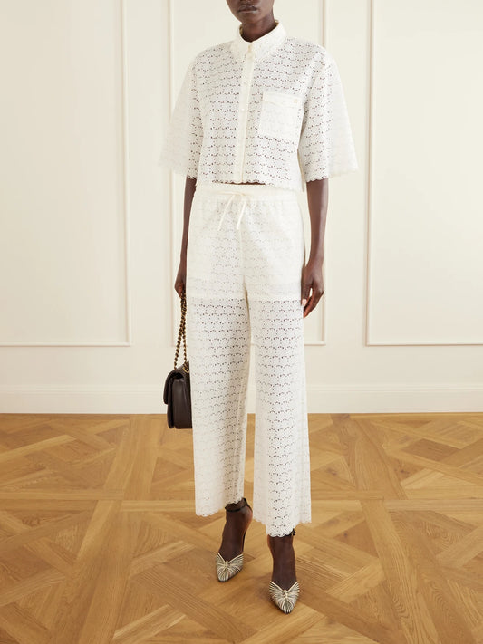 Image of a model wearing Pants. Product name - Mossi Broderie Anglaise Cotton Straight-leg Pants in Ivory colour by brand - Valentino Garavani
