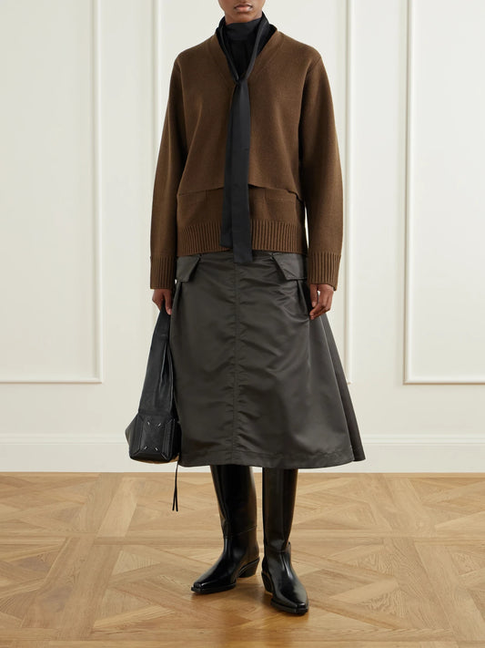 Image of a model wearing Skirts. Product name - Cargo Pleated Shell-twill Midi Skirt in Army green colour by brand - Sacai