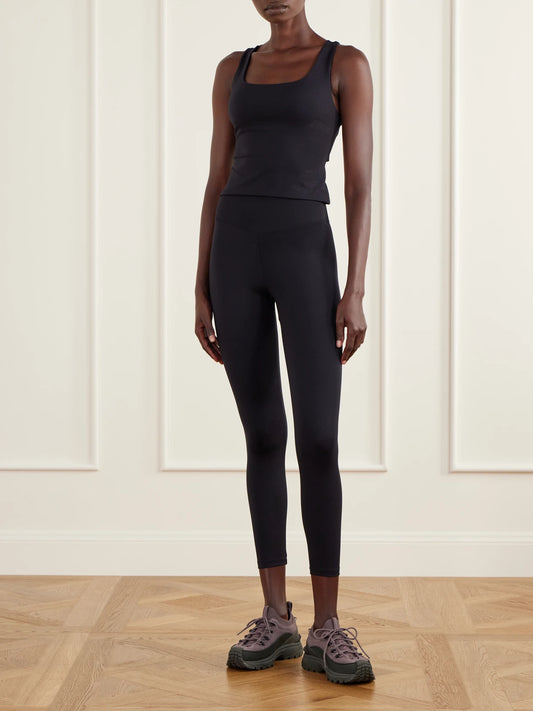 Image of a model wearing Tops. Product name - Tanni Stretch-jersey Sports Tank in Black colour by brand - Eres