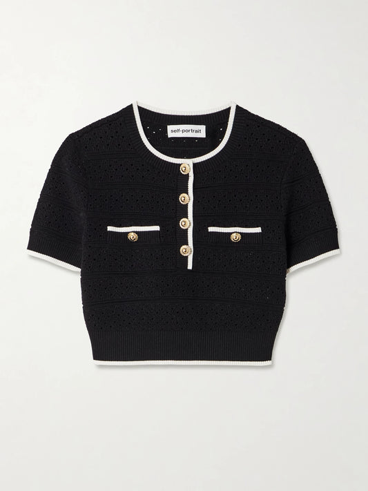 Image of a model wearing Tops. Product name - Cropped Button-embellished Metallic Cotton-blend Pointelle-knit Top in Black colour by brand - Self-Portrait
