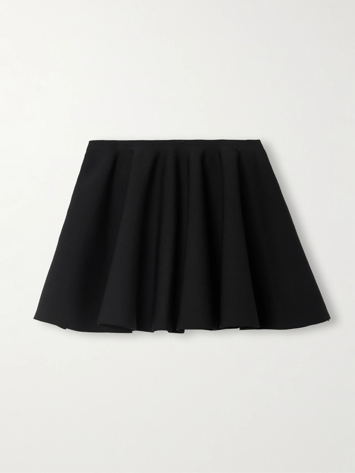 Image of a model wearing Skirts. Product name - Pleated Stretch-knit Mini Skirt in Black colour by brand - Alaïa