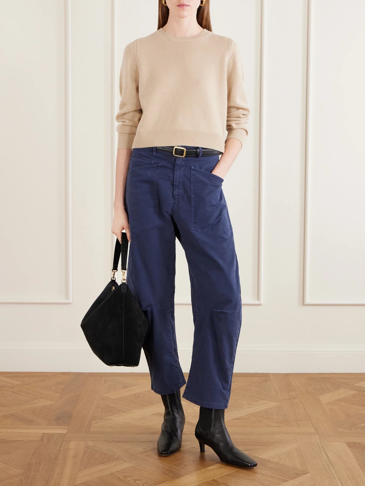 Image of a model wearing Pants. Product name - Shon Cotton-blend Twill Barrel-leg Pants in Blue colour by brand - Nili Lotan