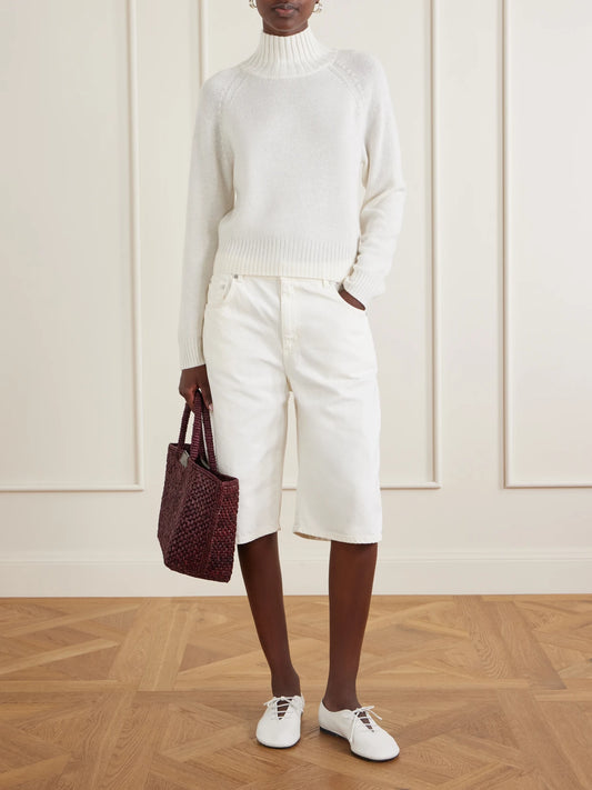 Image of a model wearing Outerwear. Product name - Mock-neck Cashmere Sweater in Cream colour by brand - Allude