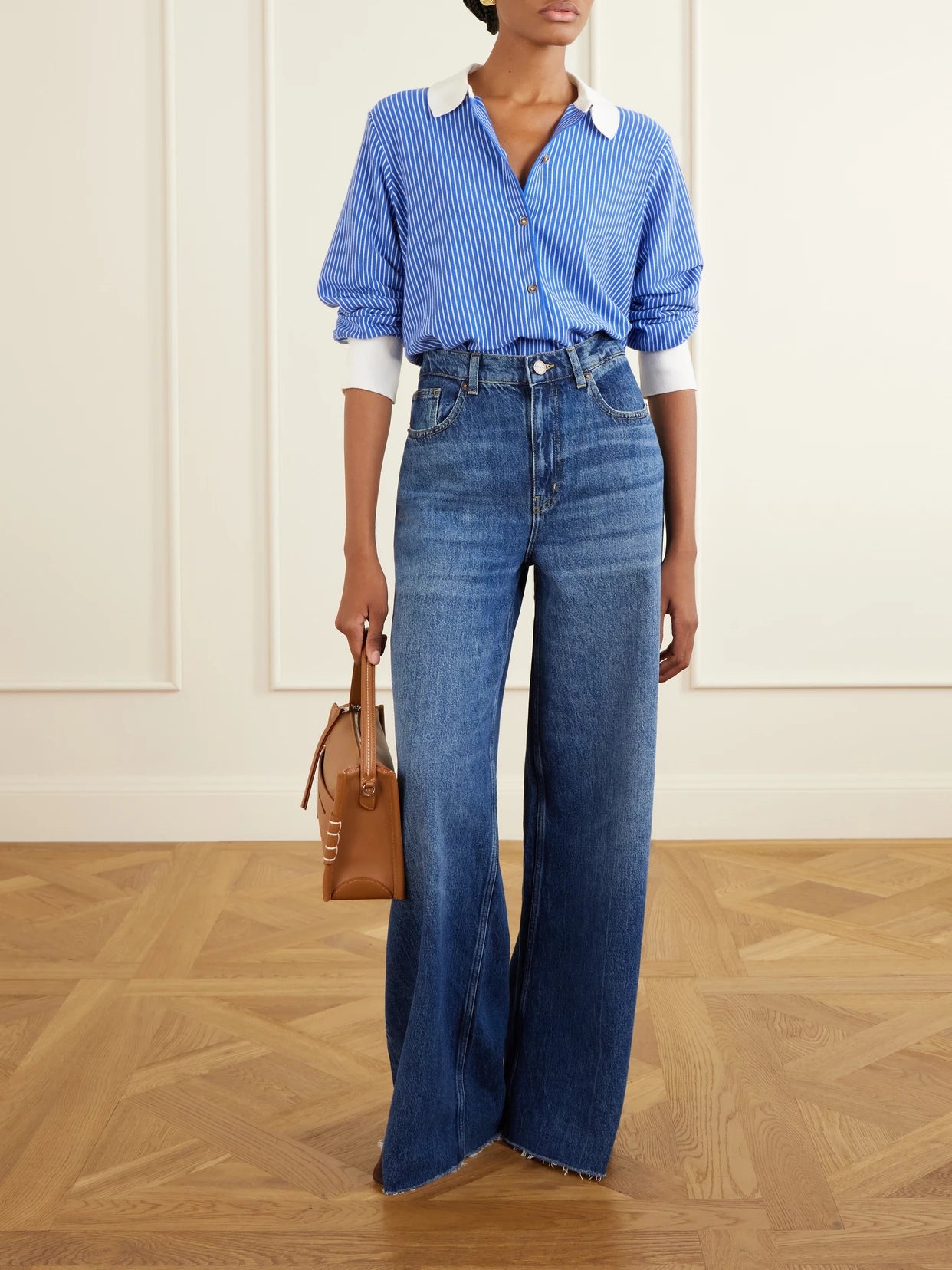 Image of a model wearing Tops. Product name - Striped Cotton-blend Knit Shirt in Cobalt blue colour by brand - La Ligne