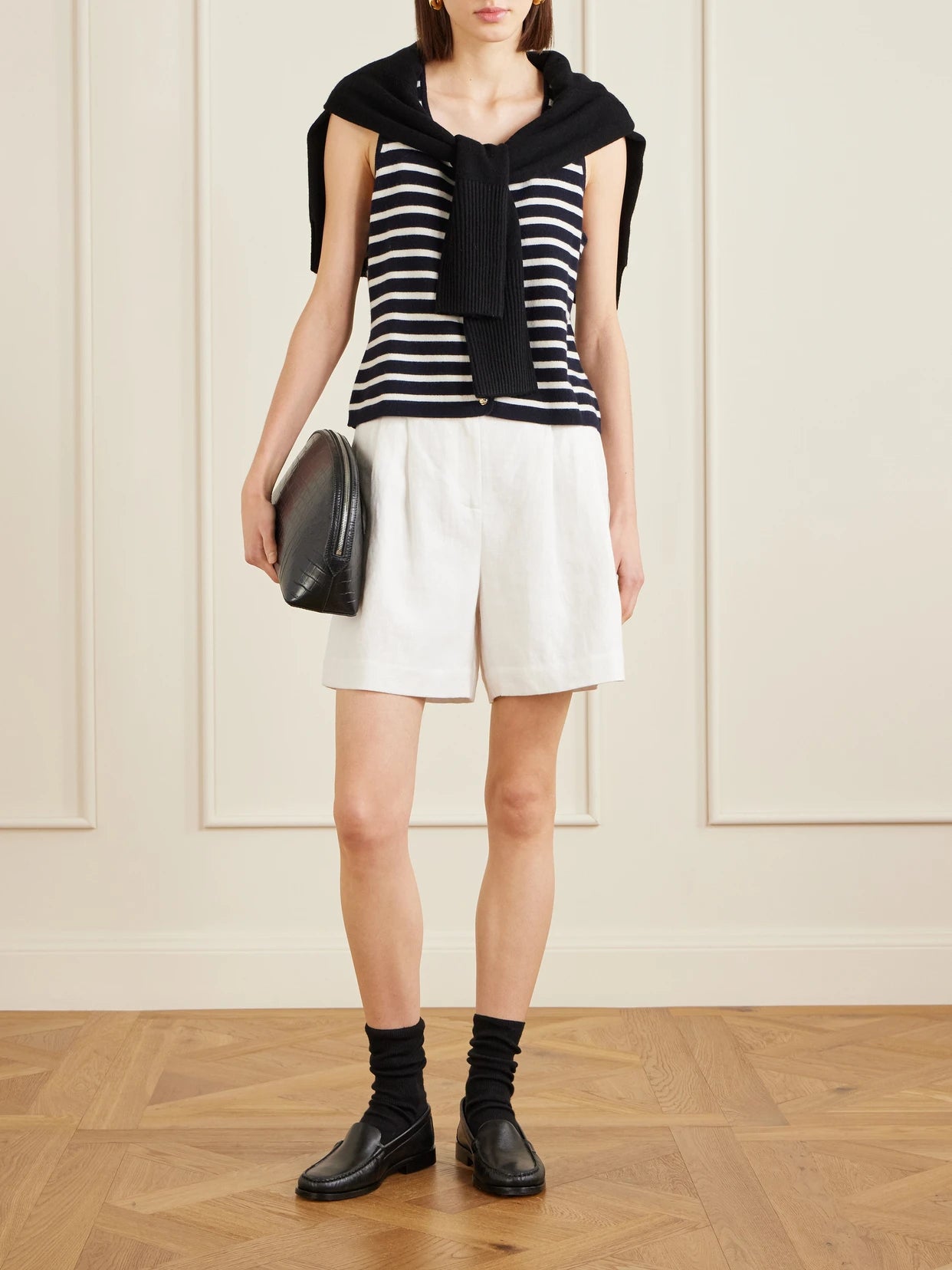 Image of a model wearing Outerwear. Product name - Striped Cashmere Vest in Black colour by brand - Allude