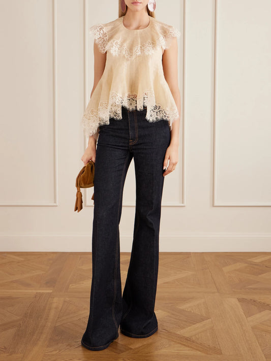 Image of a model wearing Tops. Product name - Ascent Flutter Ruffled Cape-effect Lace-trimmed Linen And Silk-blend Voile Blouse in Cream, Black colour by brand - Zimmermann