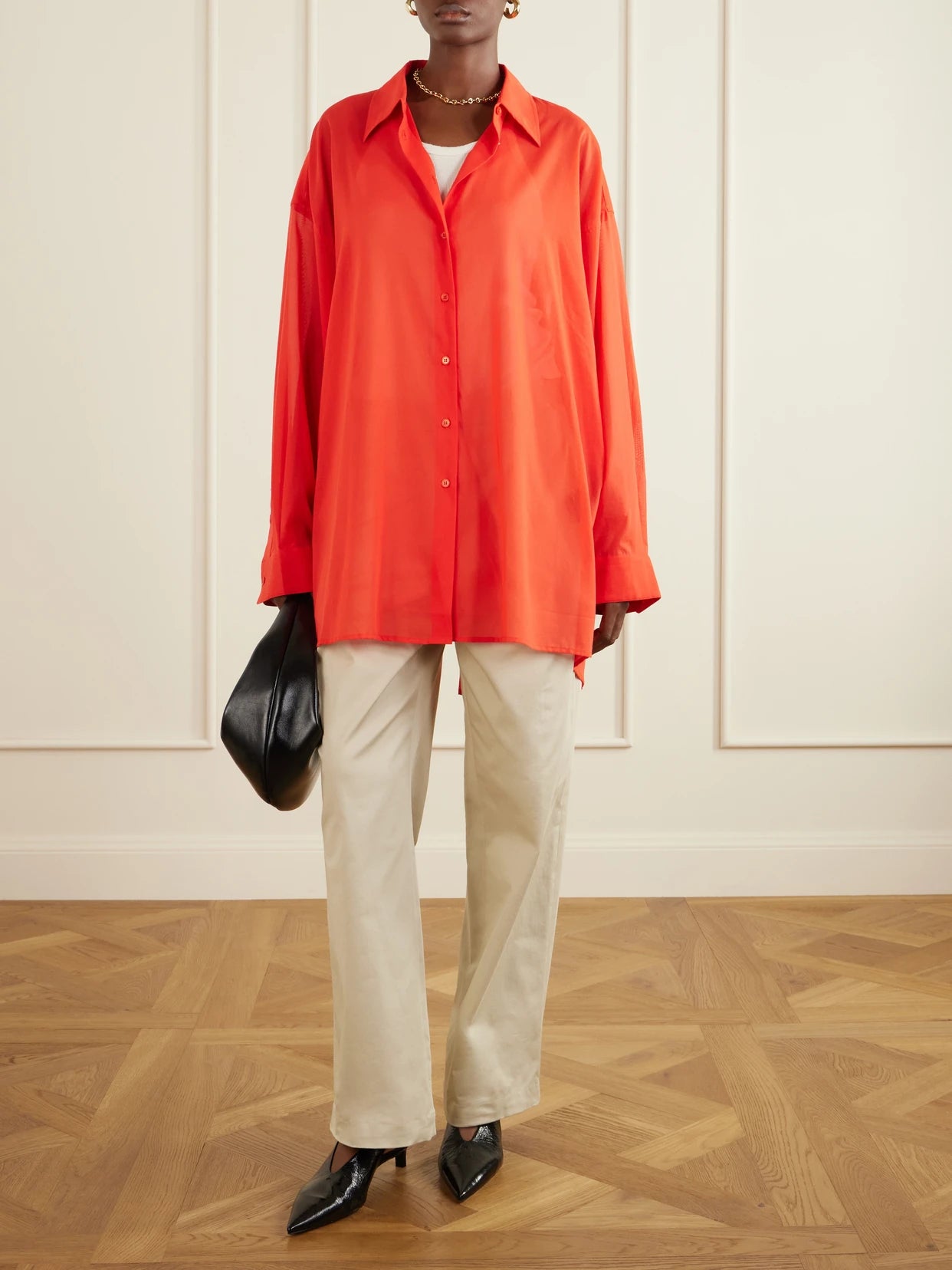 Image of a model wearing Tops. Product name - Melia Open-back Cotton Shirt in Red colour by brand - The Frankie Shop